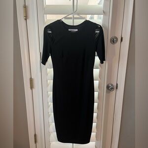 Black cocktail dress, cut outs on top of arms, very sleek, only worn once